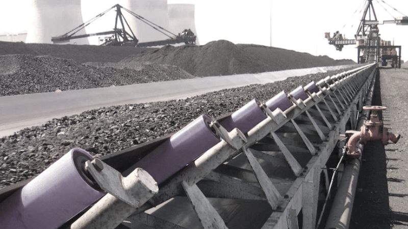 Worker inspecting an Octagonal Smooth Conveyor Belt during maintenance, ensuring long-lasting performance